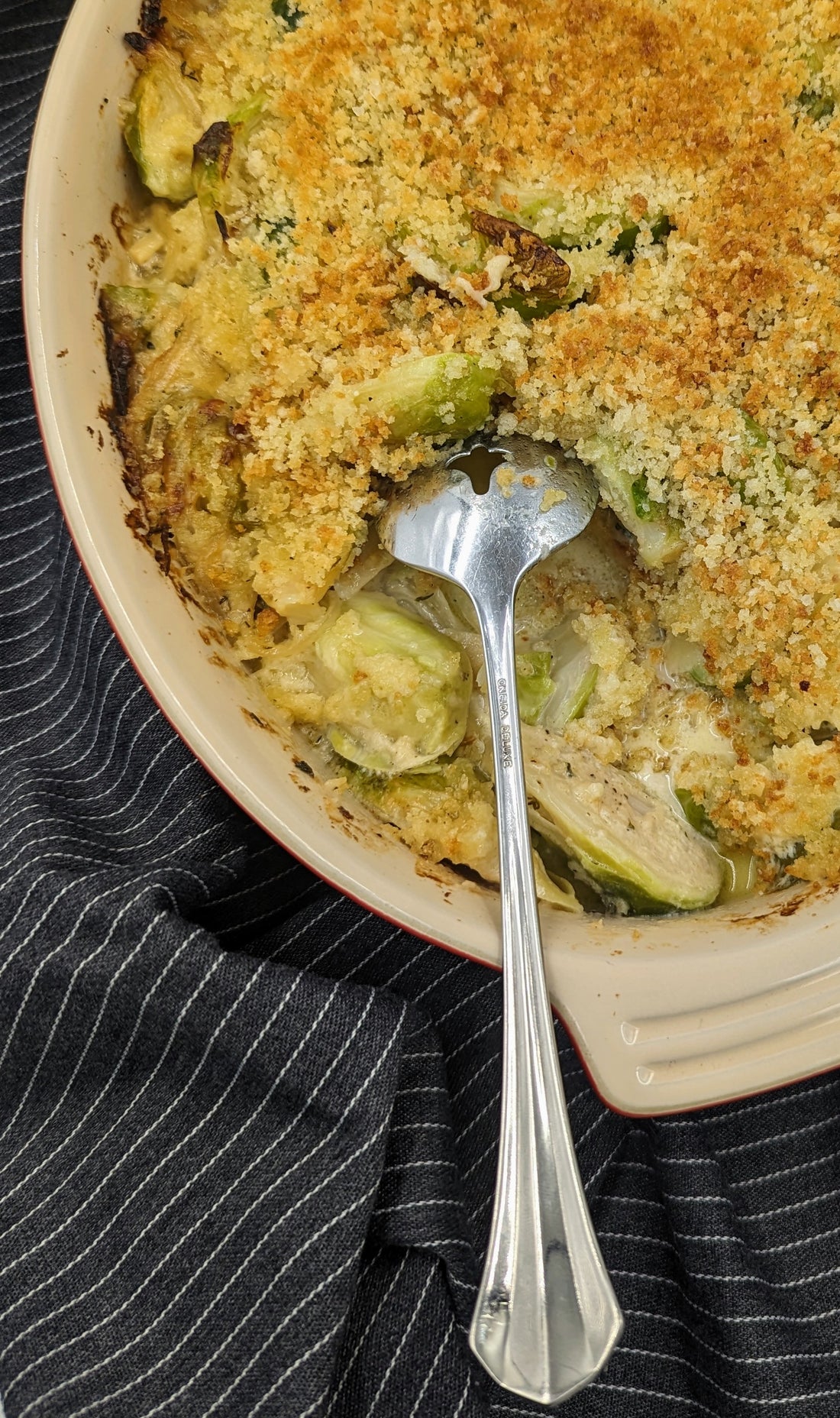 Brussel Sprout Gratin in a serving dish with a spoon