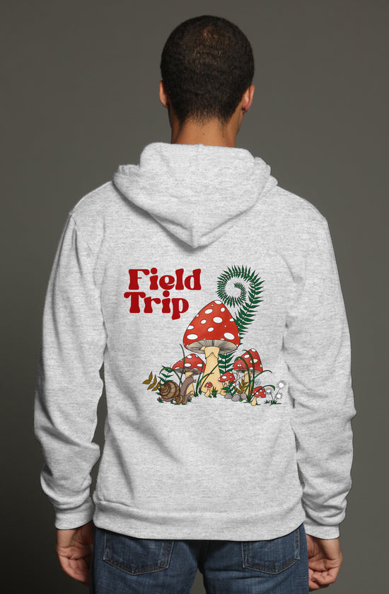 Heather grey zip hoodie with a graphic on the back of red and white mushrooms with a pair of snails.  it says field trip on the back and has a small mushroom on the front pocket area