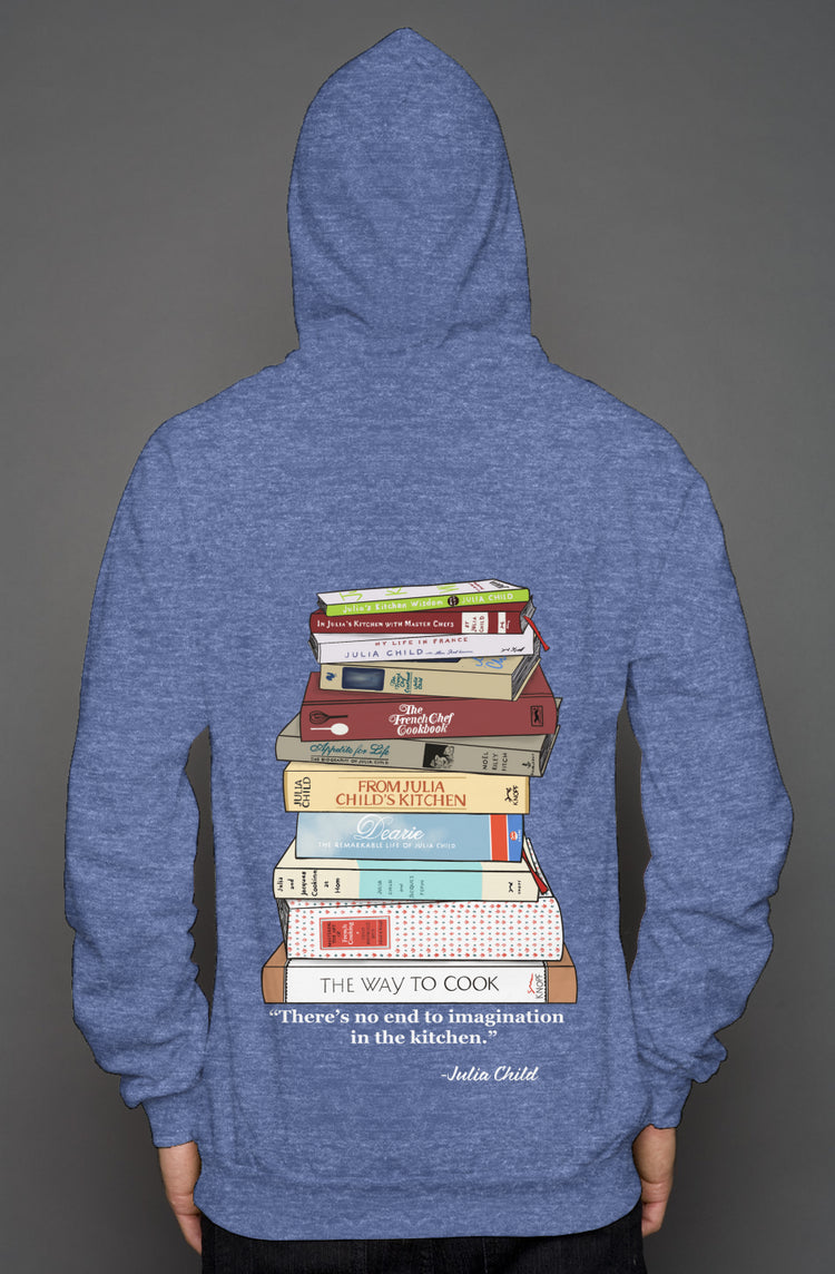 Light blue heathered pullover hoodie with a stack of Julia Child books drawn on the back with a quote from Julia Child about imagination in the kitchen